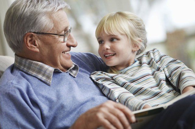 Grandfather reading to grandchild