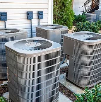 Several air conditioning units outside a building.