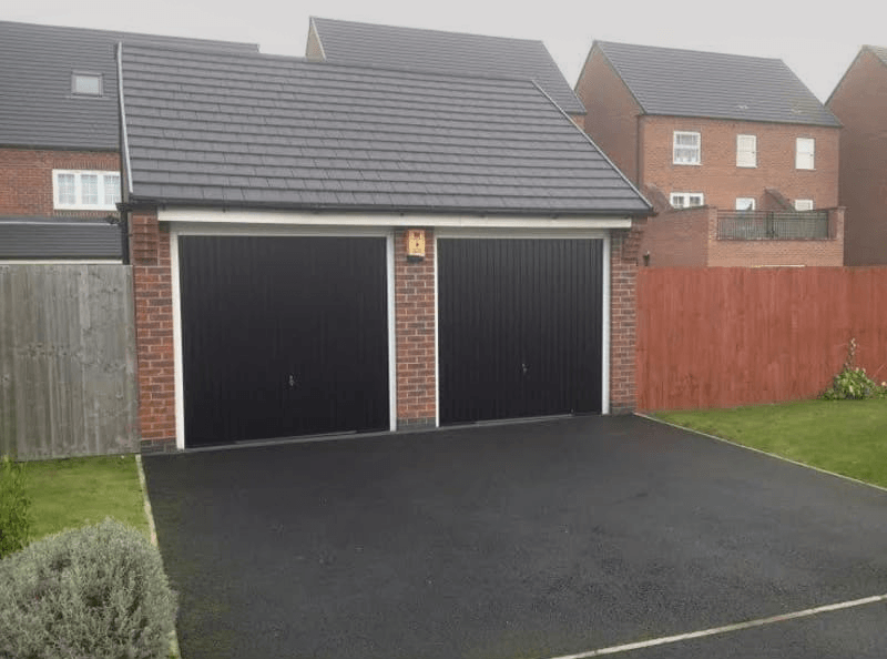 two garages with black shutters