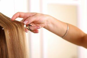 Woman holding scissors — Hair Specials in Shelby Township, MI Woman holding scissors — Hair Specials in Shelby Township, MI