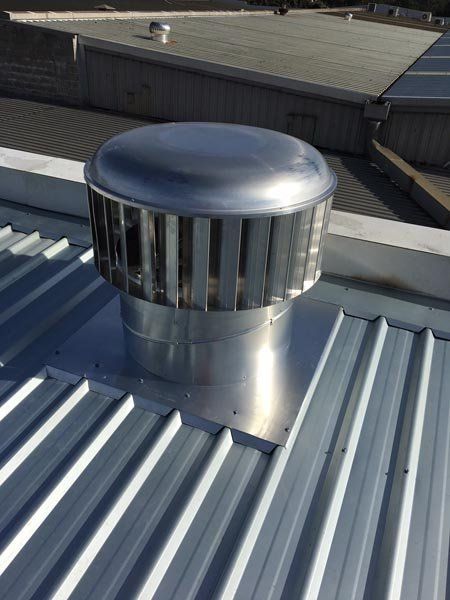 Top view of metal roof replacement with air vent