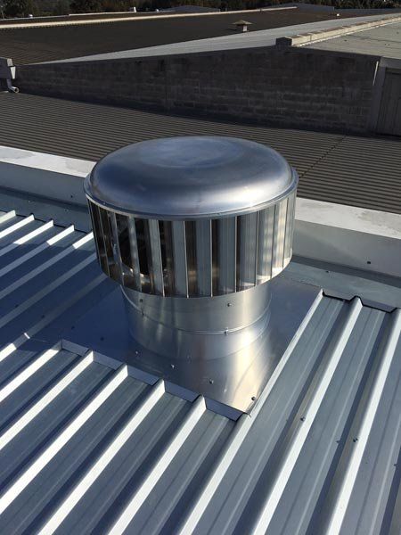 Top view of metal roof replacement with air vent