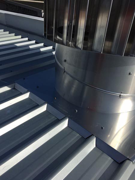 Top view of metal roof replacement with air vent