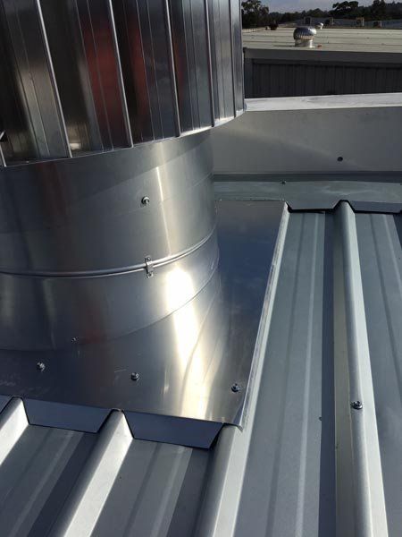 Top view of metal roof replacement with air vent