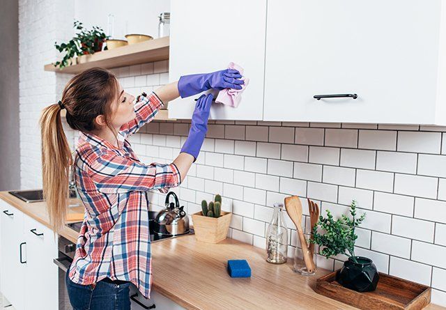 Home Cleaning Contractor — Lady Cleaning in the Kitchen in Prairieville, LA