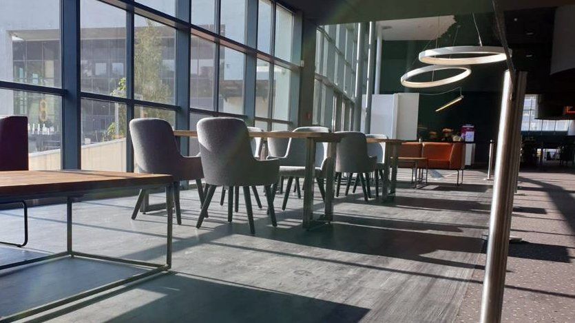 Upholstered contract chairs with black wooden legs