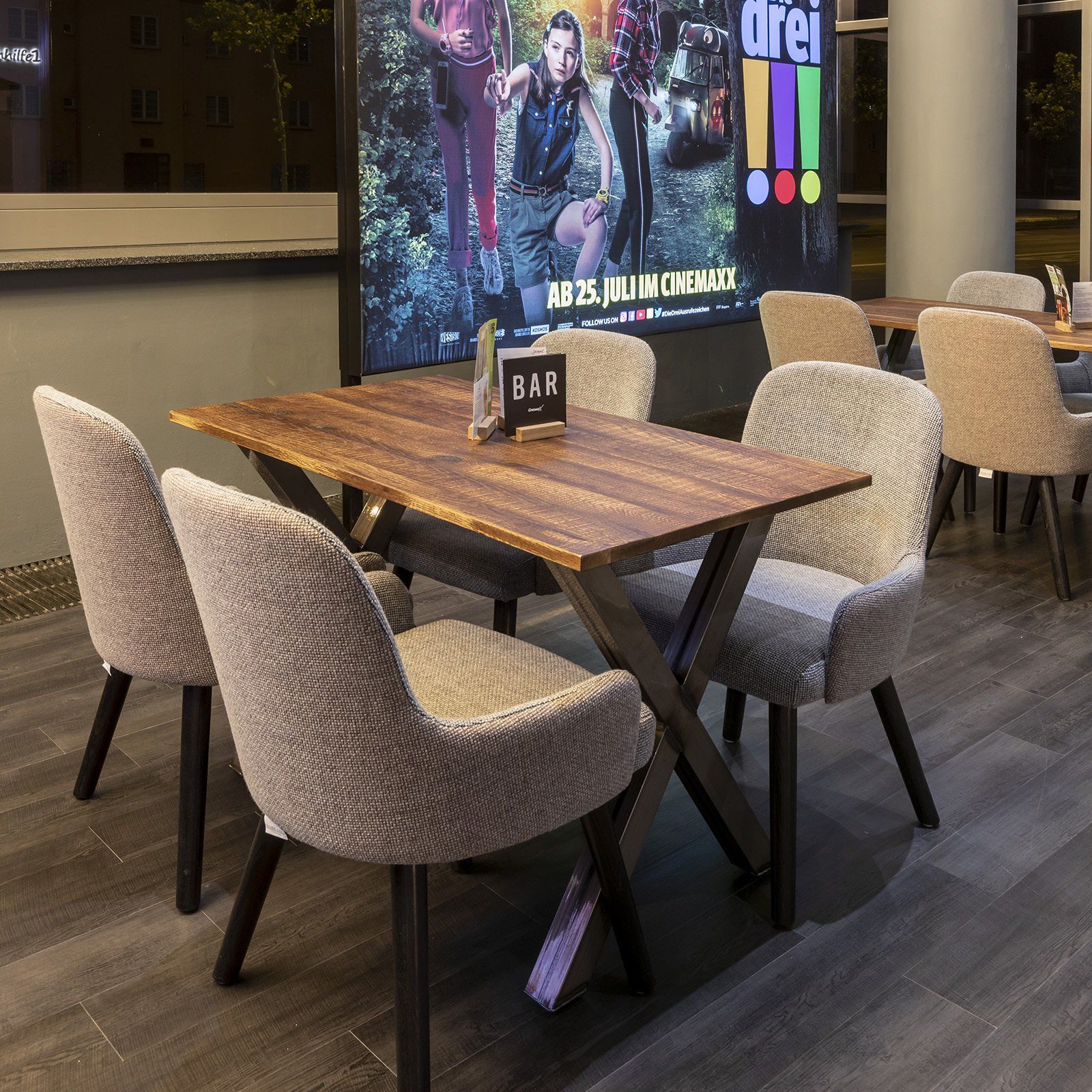 Cinema upholstered cafe chairs and wooden tables