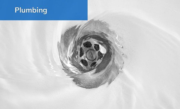 Whirlpool water draining in a sink, plumbing concept.