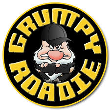 Grumpy roadie cartoon character in a black hat, arms crossed, inside a black and yellow circle.