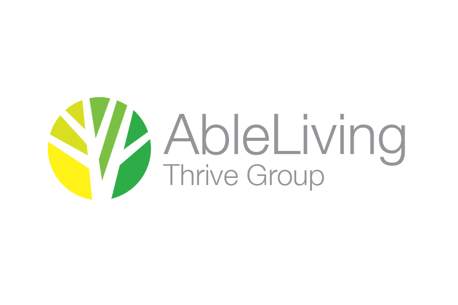 The logo for able living thrive group is a tree in a circle.