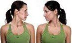 Two women in green tank tops are standing next to each other and looking at each other.