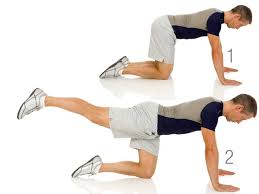A man is doing a leg lift exercise on his knees.