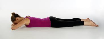 A woman is laying on her stomach on the floor.