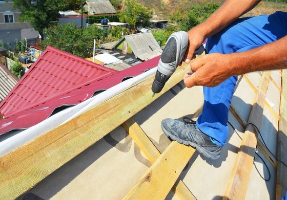 Roof Repair And Maintenance ─ Roofing Contractor Installing Metal Roof Tile in Tucson, AZ