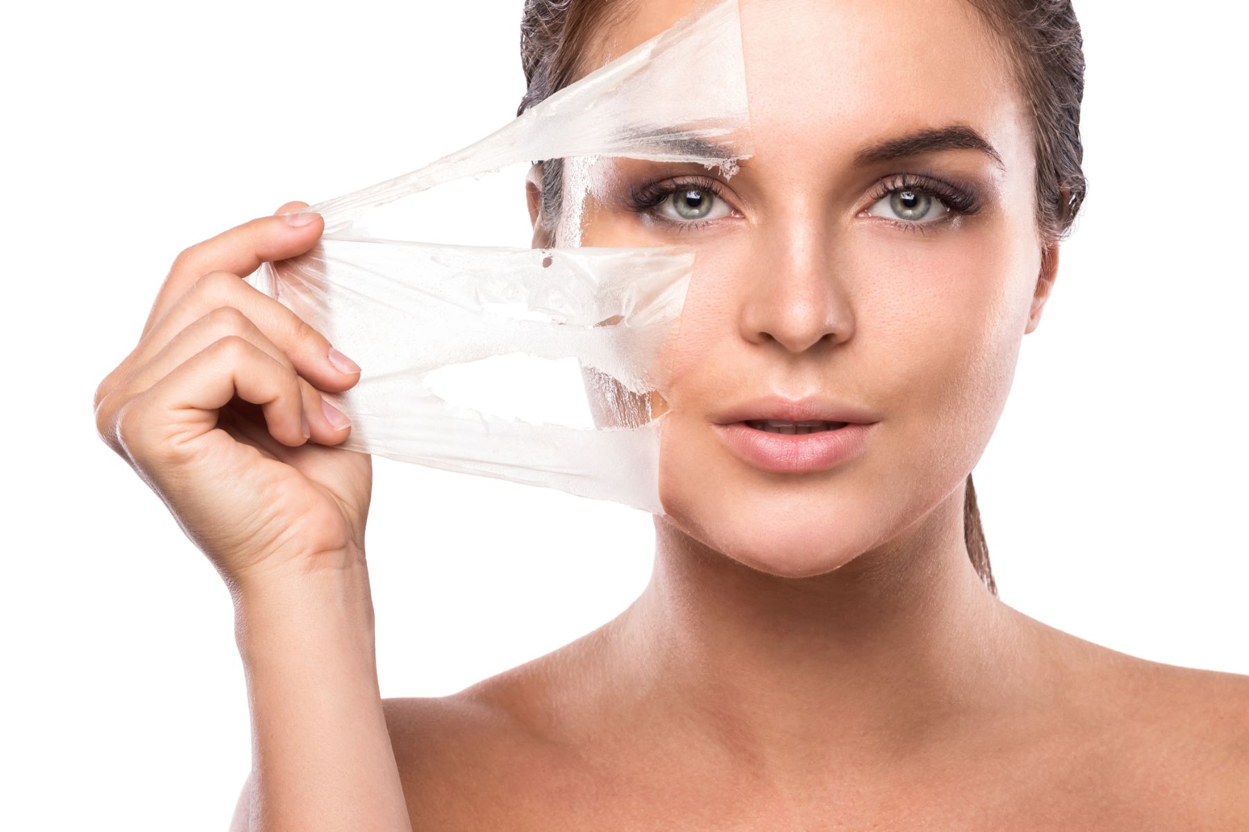 woman peeling off facial mask