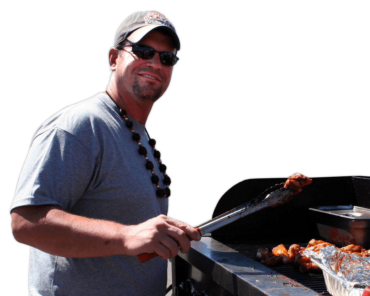 A man is cooking food on a grill with a spatula
