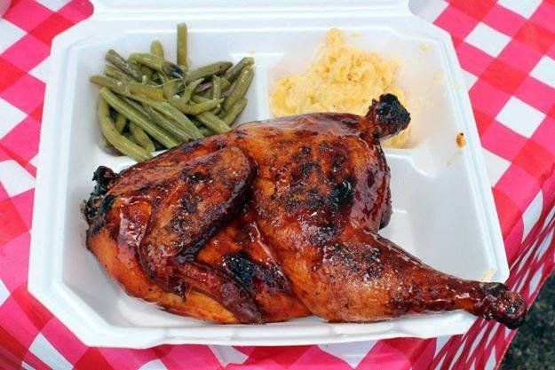 A styrofoam container filled with chicken green beans and mashed potatoes