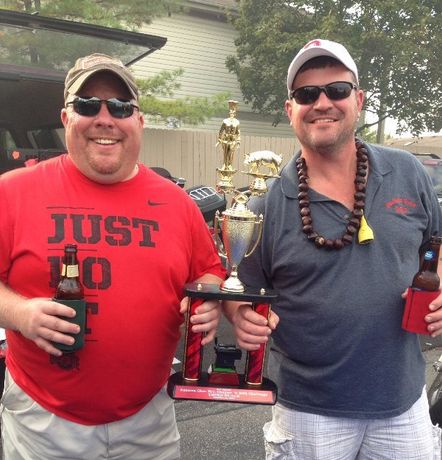 Two men standing next to each other one wearing a red shirt that says just 10