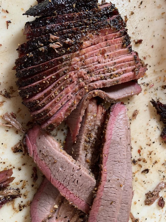 A close up of sliced meat on a white plate
