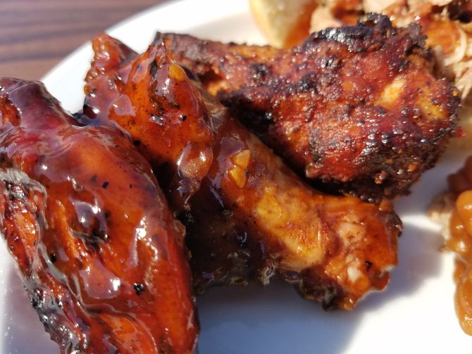 A close up of chicken wings on a white plate