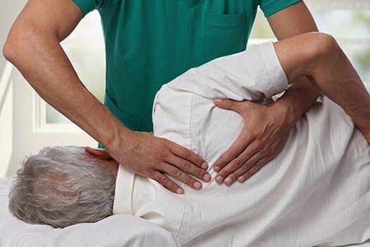 Man Having Chiropractic Back Adjustment - Chiropractic Services in Anderson, SC