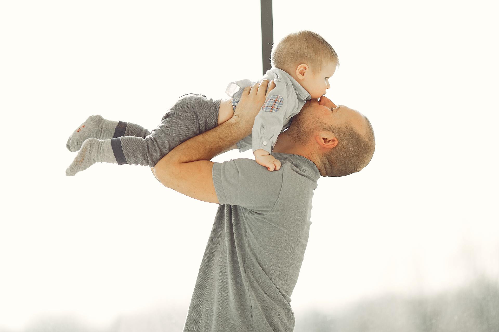 father playing with baby son
