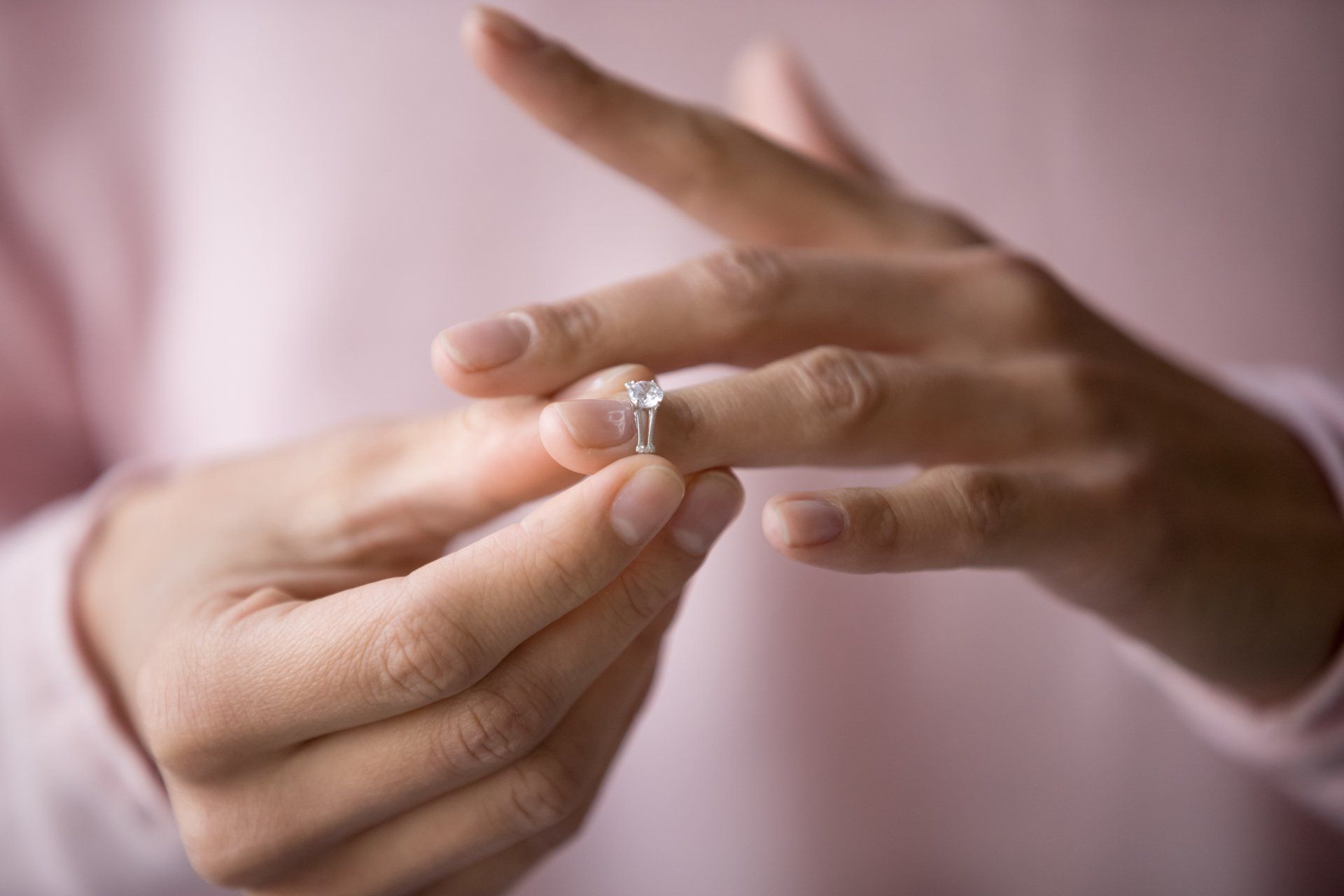 Close up of decisive woman take off wedding ring make decision breaking up with husband, young female remove engagement jewelry having relationships problems filing for divorce or annulment