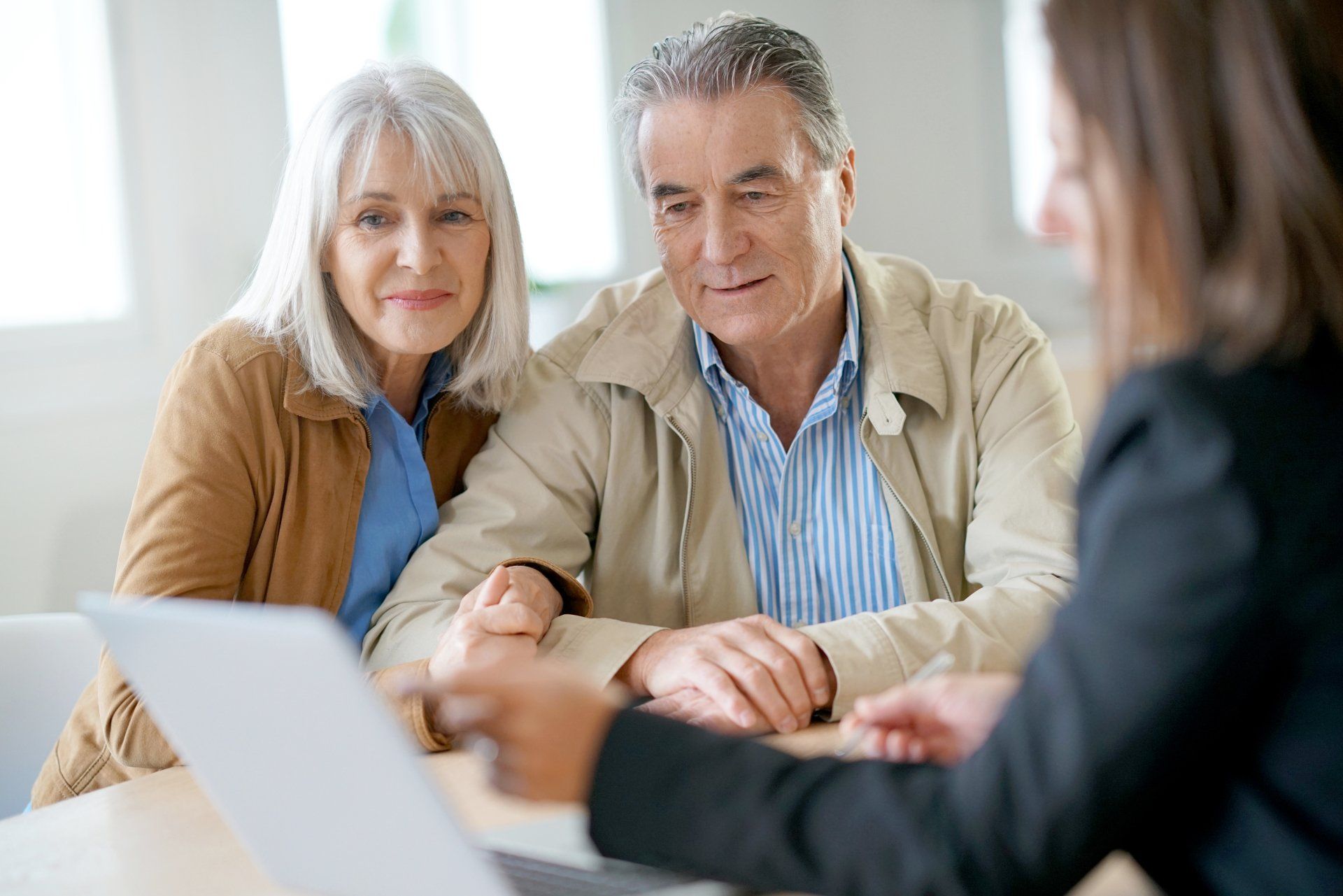 Senior couple meeting financial adviser for investment