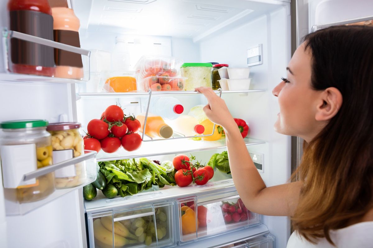 Refrigeration Repair — Woman Checking Refrigerator in Hampton Roads, VA Refrigeration Repair — Woman Checking Refrigerator in Hampton Roads, VA