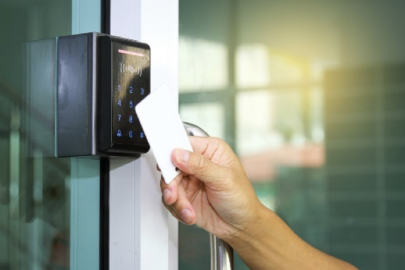 A person is using a key card to open a door.