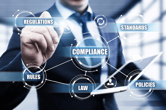 A man is pressing a button on a screen that says compliance