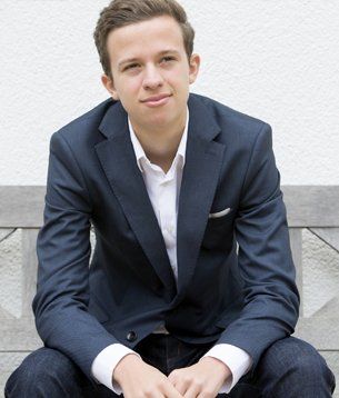Young man in a suit after clothing alterations done at our studio in Kenmore