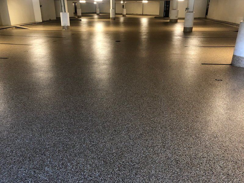 Tan flake polyaspartic coating in a commercial parking garage