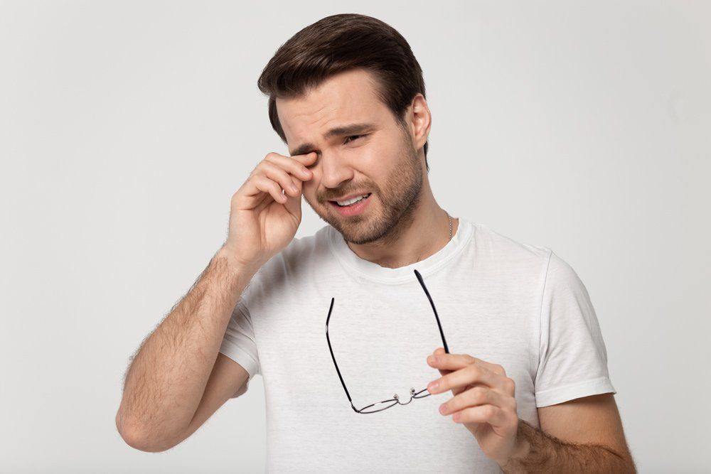 Man Scratching His Dry Eye — Big Rapids, MI — Crew & Boss Eye Associates