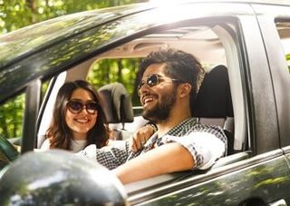 Husband and Wife Laughing at the Car — Bail Bonds in New Castle, IN