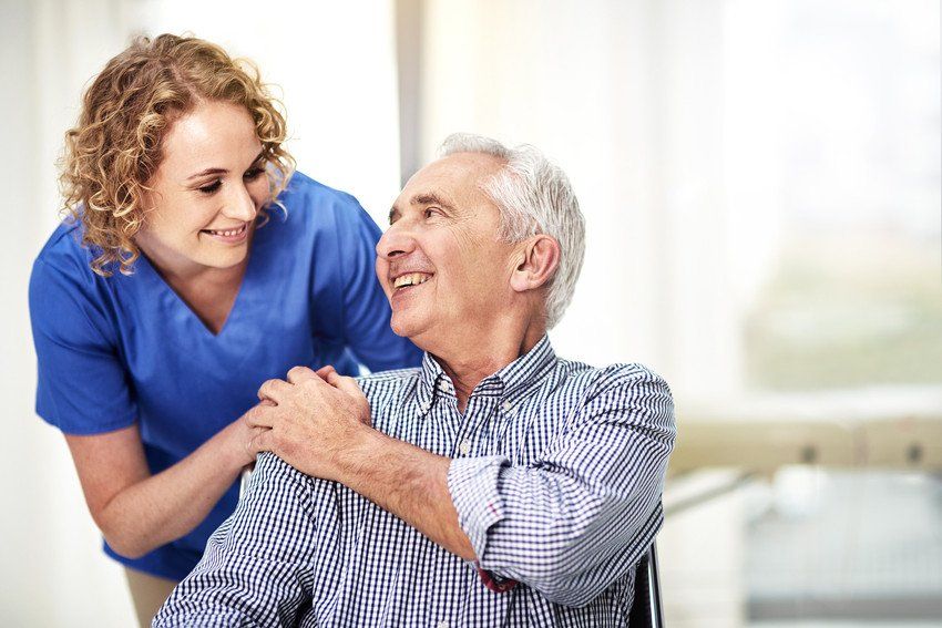 Shot of a female carer talking to her patient in the nursing home