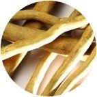 Eurycoma Longifolia - A pile of thin, light brown, woody plant root strips with pale, fibrous interiors.