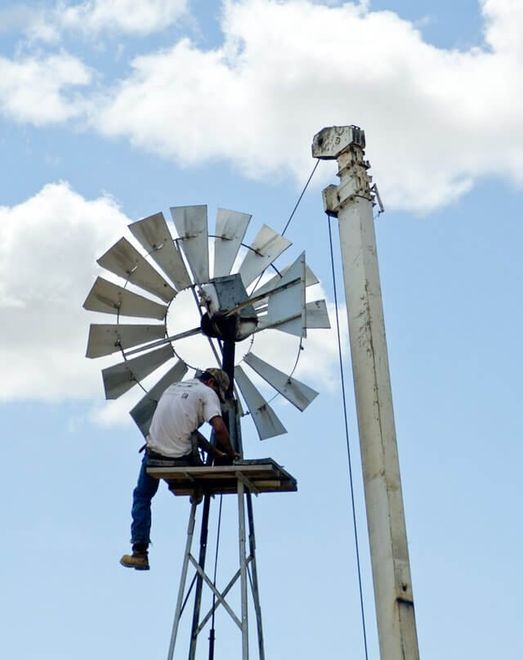 worker installing a windmill