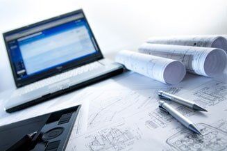 Site Development — Laptop And Blue Print Of A Building in Latham, NY Site Development — Laptop And Blue Print Of A Building in Latham, NY