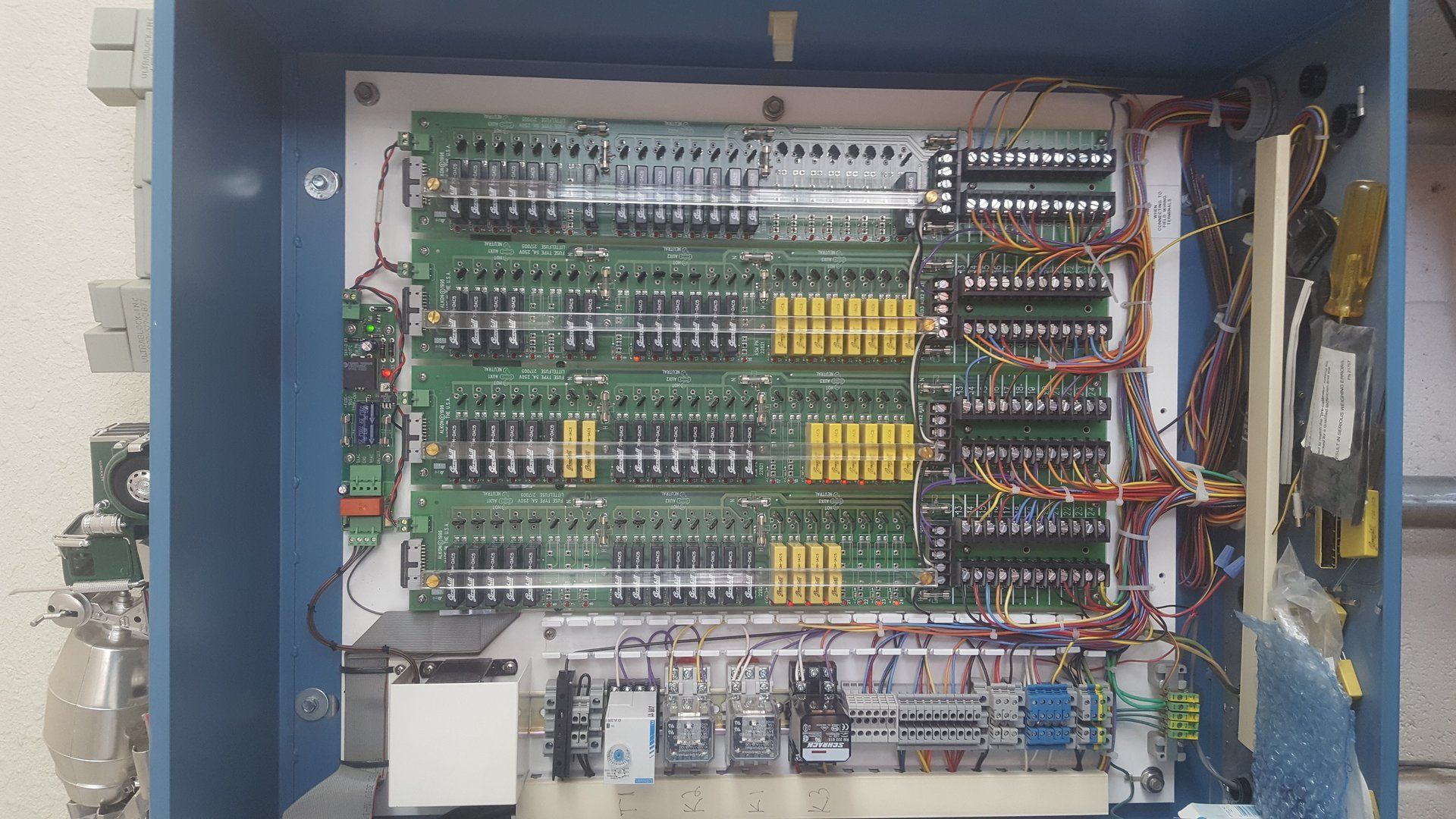 A blue box with a bunch of wires coming out of it