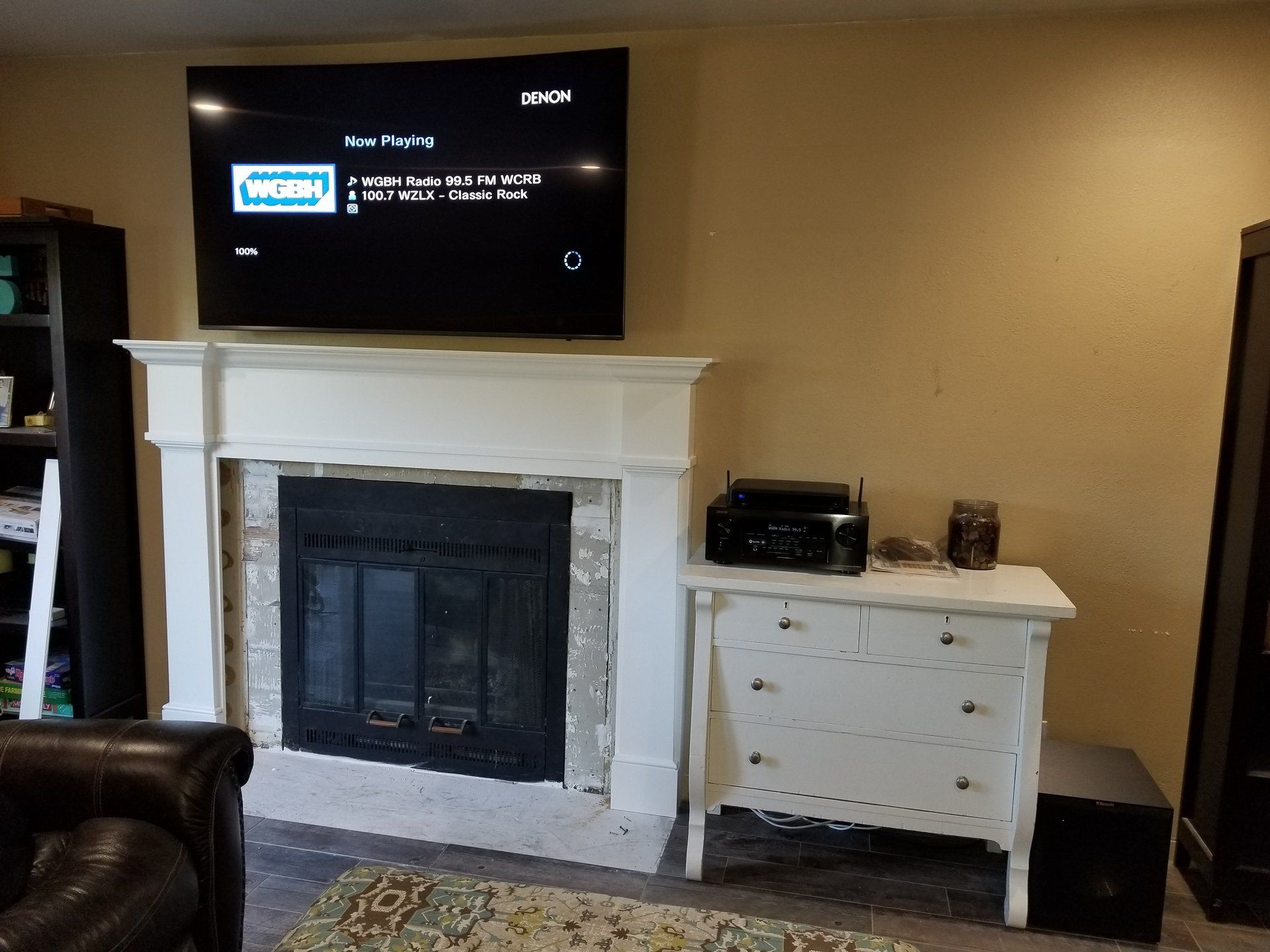 A living room with a fireplace and a flat screen tv