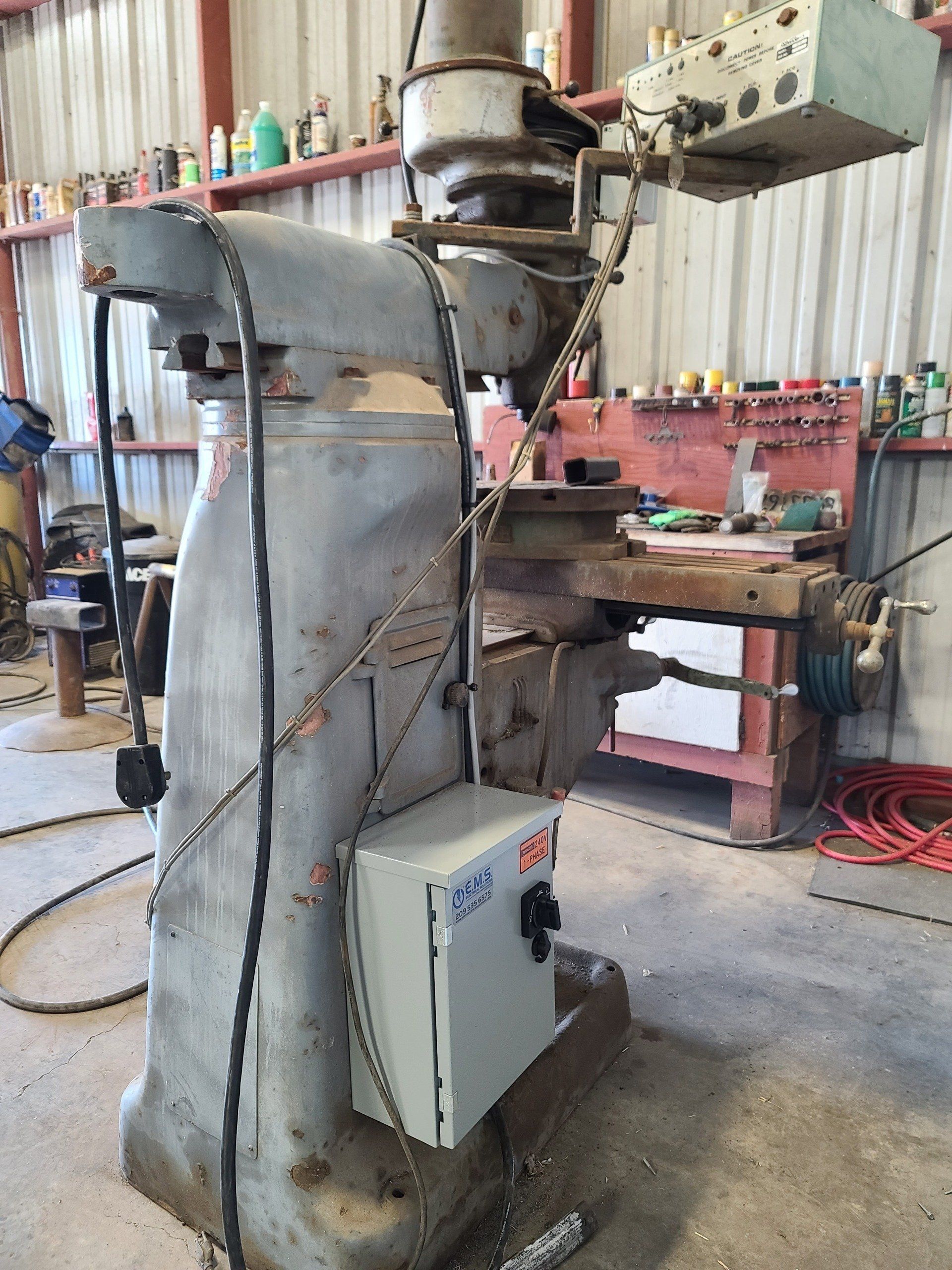 A machine is sitting in a garage next to a workbench.