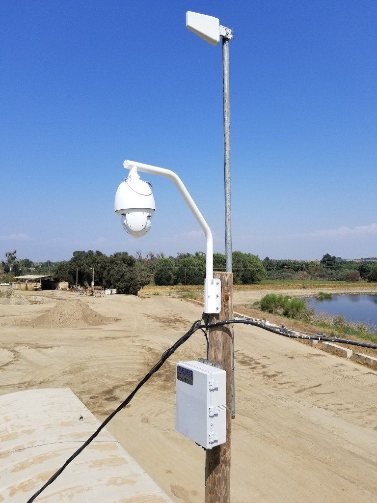 A camera on a pole with a box attached to it