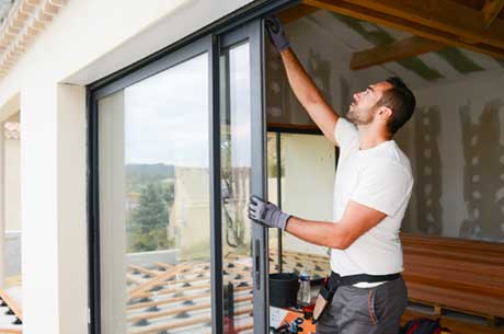 Man Installing Window — Binghamton, NY — Robert J Green & Son Man Installing Window — Binghamton, NY — Robert J Green & Son