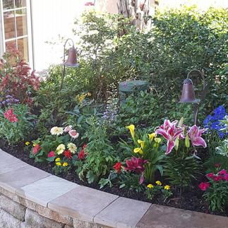 Beau Monde installed colorful flower bed with stone border in Opelousas, LA