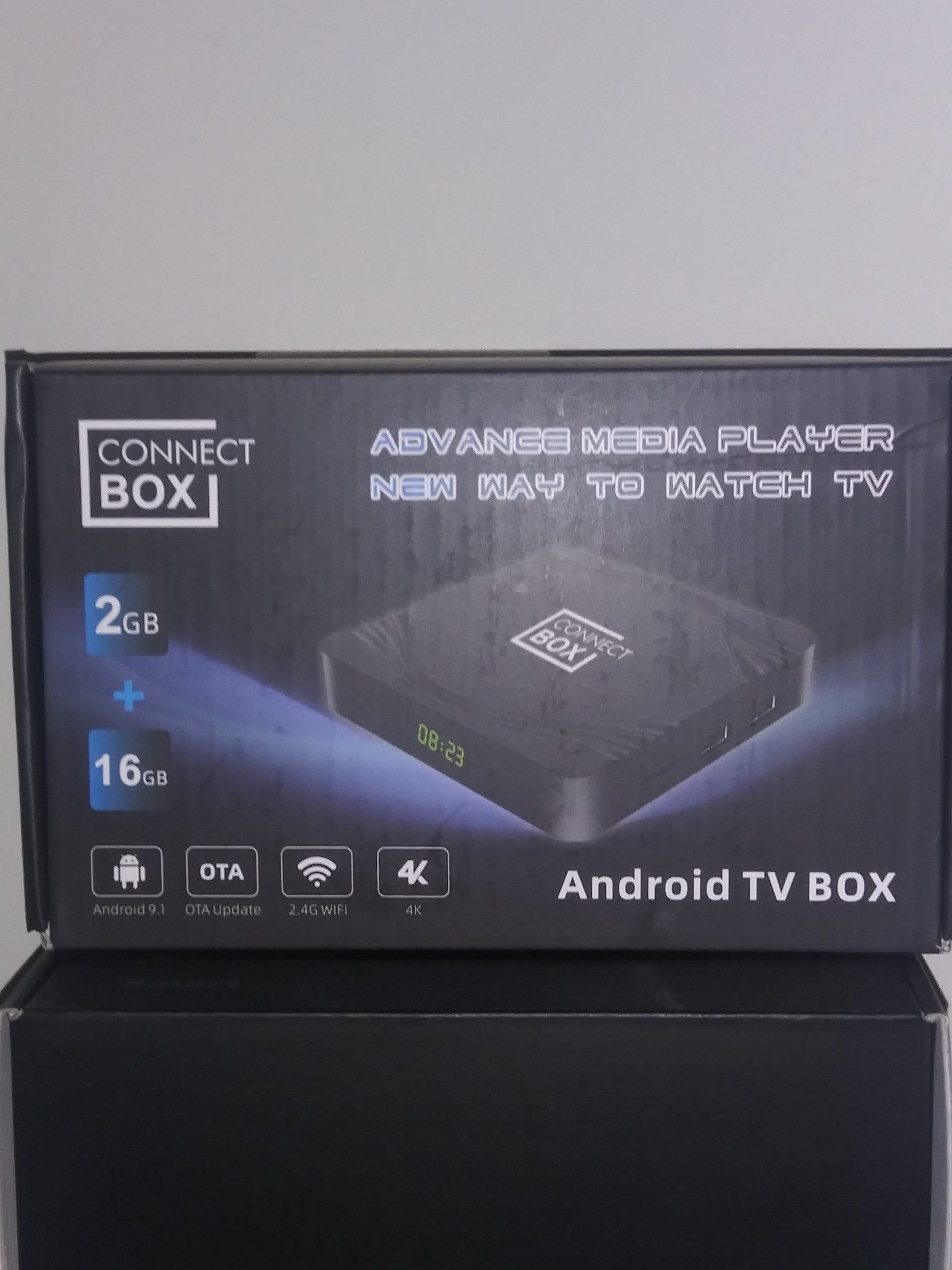 An android tv box is sitting on top of a black box.