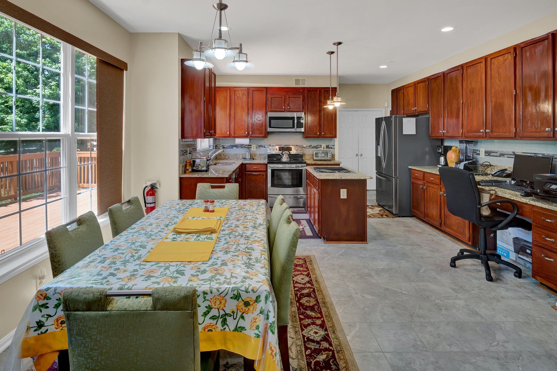 A kitchen with a table and chairs in it