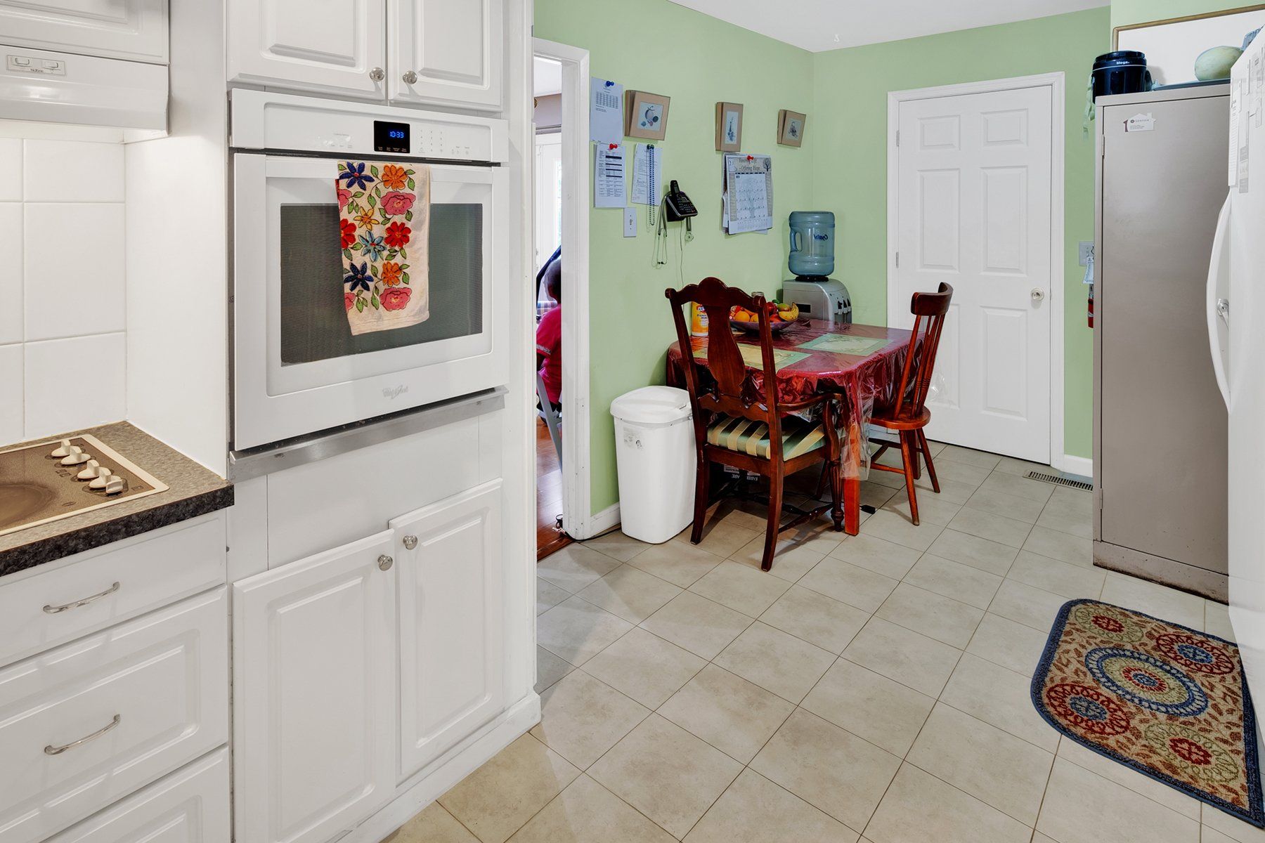 A kitchen with a table and chairs and a microwave oven