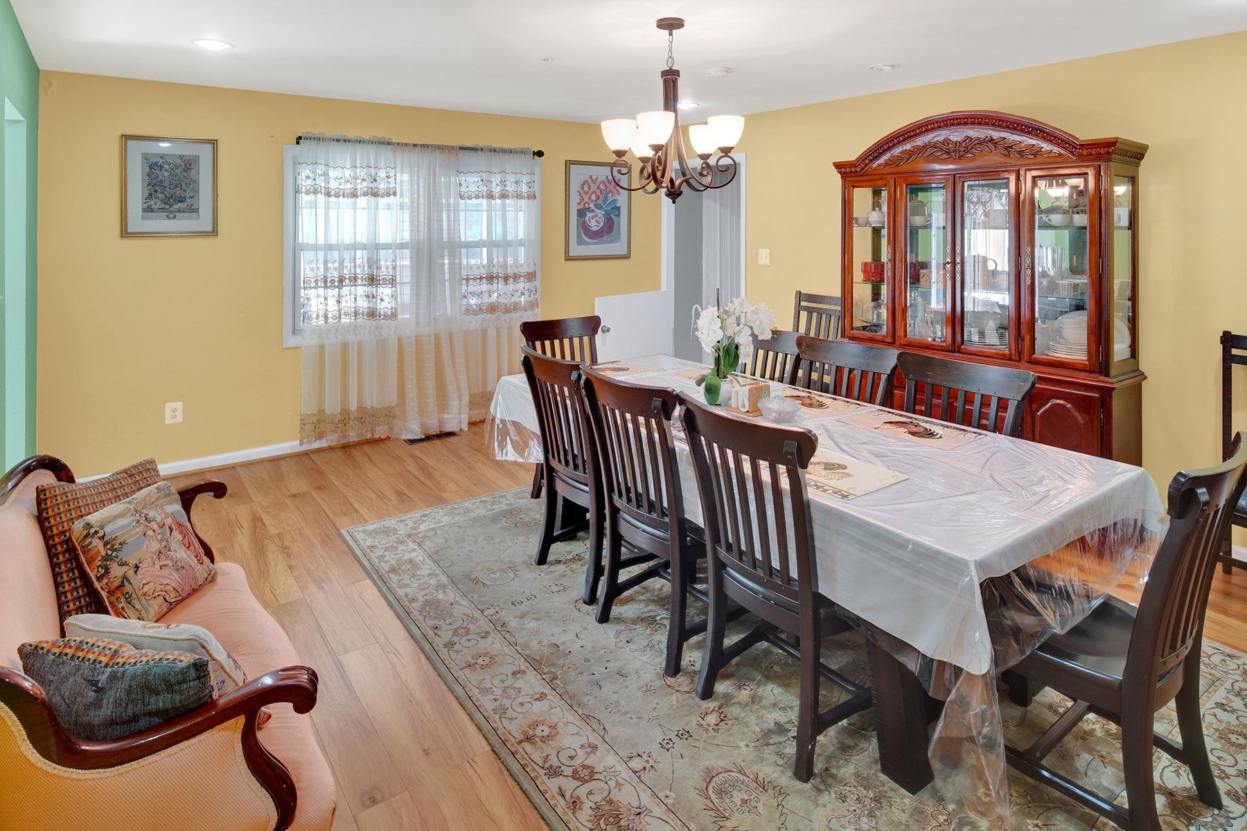A dining room with a long table and chairs