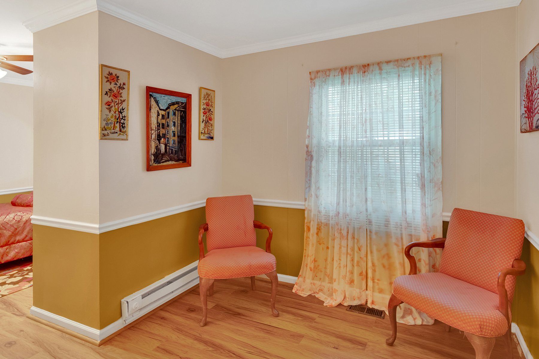 A living room with two chairs and a window.